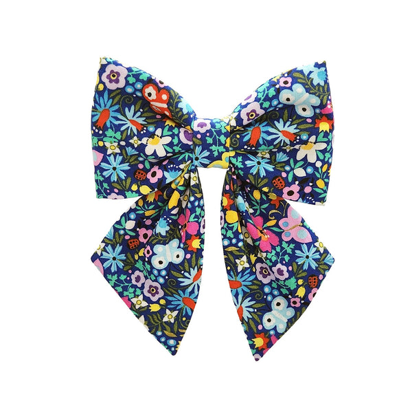 Navy dog sailor bows that attach to the collar for small and big dogs and puppies in a whimsical floral print fabric