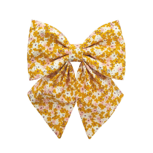 dog sailor bows for small, medium and large dogs that attach to the dogs collar in a golden yellow and pink floral print