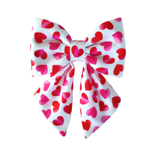 Dog sailor bows in a fun red and pink heart print that attach to the collar in sizes for small medium and large dogs