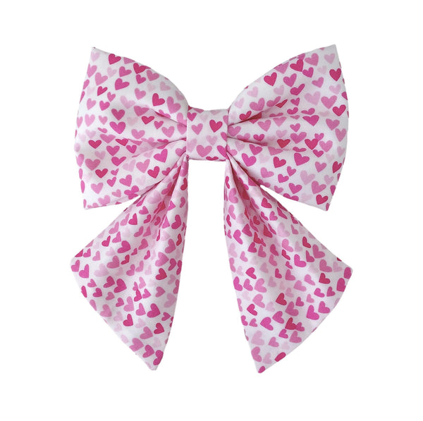 Cute dog sailor bows with tiny pink hearts that attach to the collar in sizes for small medium and large dogs