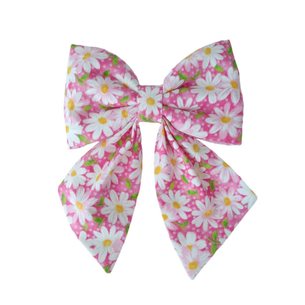pink dog sailor bows with white daisies for small and large dogs that are attached to the the collar