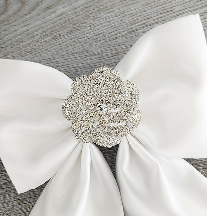 White satin dog sailor bow with crystal flower close-up view.