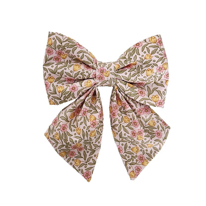 Dog bows in a pink and yellow mini floral print on a blush background for the collar.
