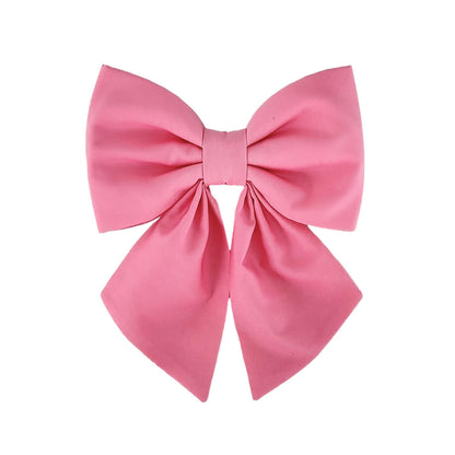 A pink dog sailor bow that attaches to the collar.
