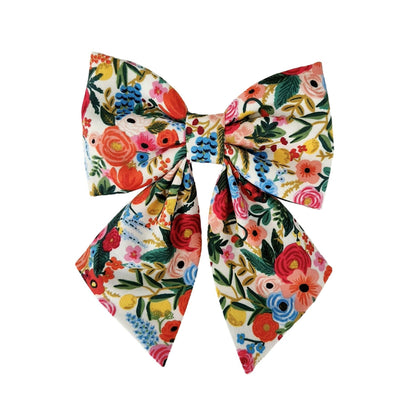 A dog sailor bow for girl dogs with colorful flowers that attaches to the collar.