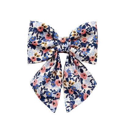 A dog sailor bow for the collar in pink and blue floral print