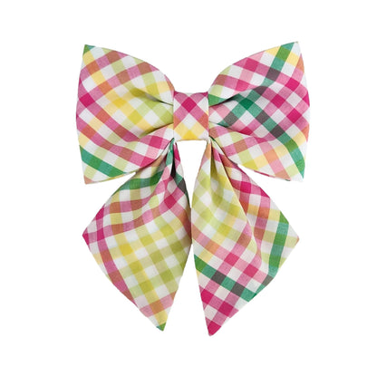 A plaid dog collar bow for girls in a hot pink, yellow, lime and green print with a white background.