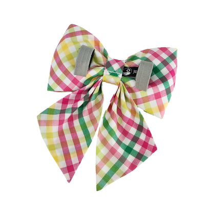 A back view of a plaid girl dog bow with Velcro tapes to attach it to the collar.