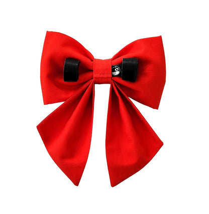 A red dog sailor bow with Velcro Brand strips to attach the bow to the collar. This is a back view.