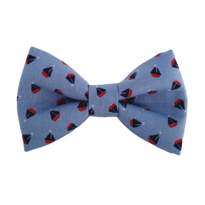 blue dog bow tie with a sailboat print for large and small dogs that attach to the dogs collar